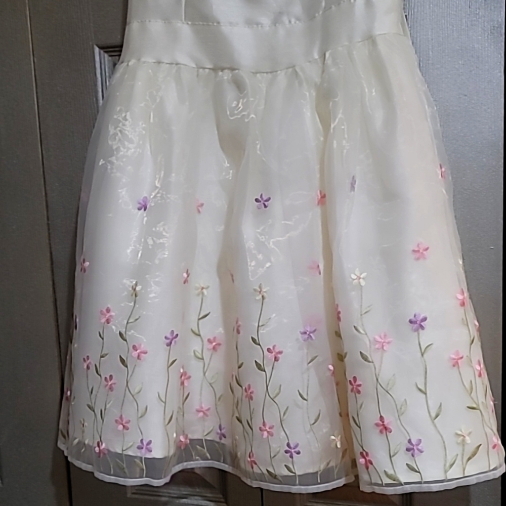 Special Editions Girls Ivory Dress With Beautiful Floral Accents On the Bottom.